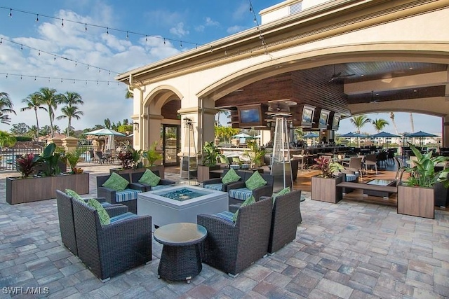 view of patio featuring an outdoor living space with a fire pit