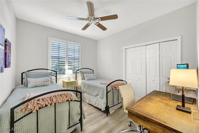 bedroom with a closet, wood finished floors, and a ceiling fan