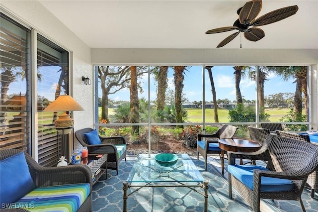 sunroom / solarium featuring a wealth of natural light and a ceiling fan