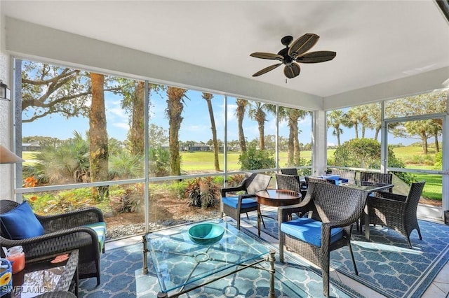 sunroom / solarium featuring a ceiling fan