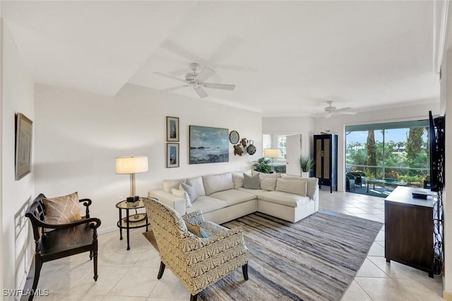 living room with light tile patterned floors, a ceiling fan, and baseboards