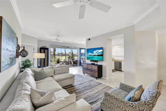 living room featuring light tile patterned floors, ceiling fan, ornamental molding, and baseboards