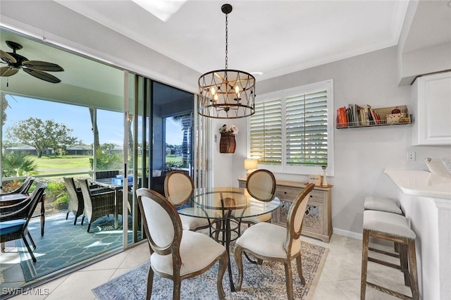 dining room featuring light tile patterned floors, baseboards, crown molding, and ceiling fan with notable chandelier