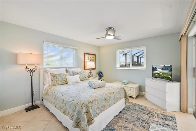 tiled bedroom featuring multiple windows and ceiling fan