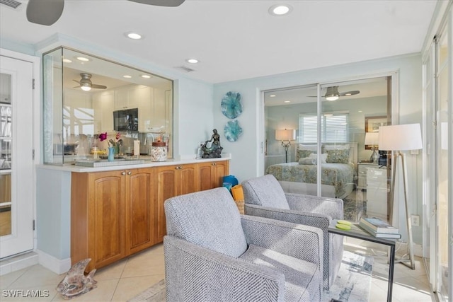 interior space featuring light tile patterned flooring, ceiling fan, and backsplash