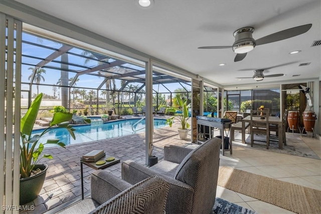 view of pool with a patio, ceiling fan, and glass enclosure