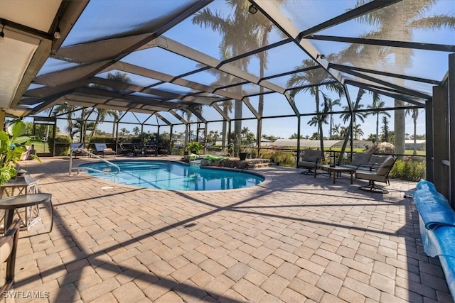 view of pool featuring a patio and glass enclosure