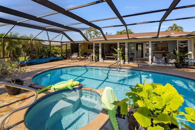 view of pool featuring a lanai, a patio area, and an in ground hot tub