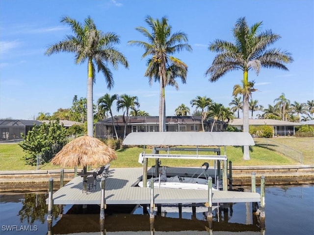 dock area featuring a water view and a lawn