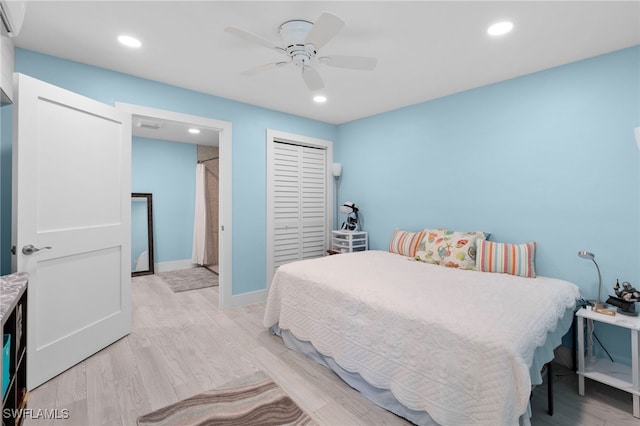 bedroom featuring light wood-style floors, ceiling fan, a closet, and recessed lighting