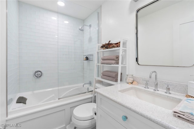 full bath with bathtub / shower combination, vanity, and toilet