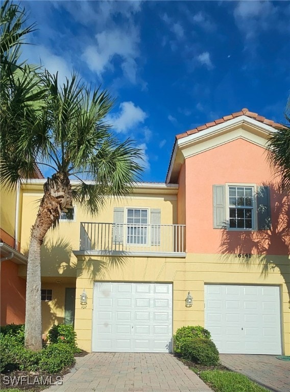 view of front of home featuring a balcony and a garage