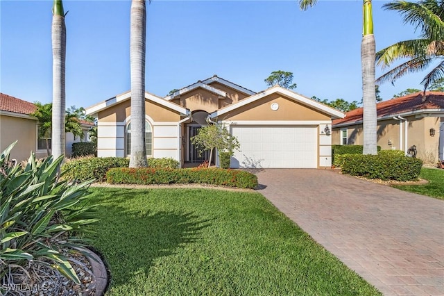 view of front of home with a garage and a front yard