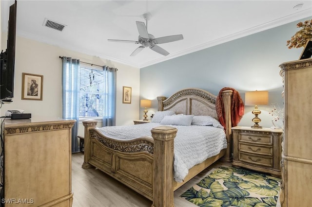 bedroom featuring crown molding, ceiling fan, and light wood-type flooring