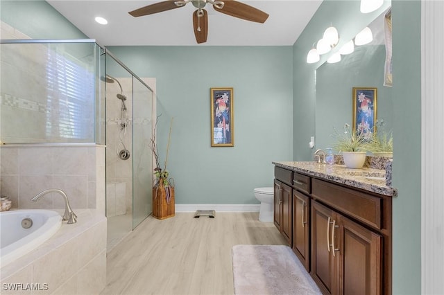 full bathroom with ceiling fan, hardwood / wood-style floors, vanity, plus walk in shower, and toilet