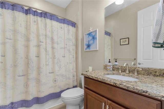 full bathroom with vanity, shower / bath combo, and toilet