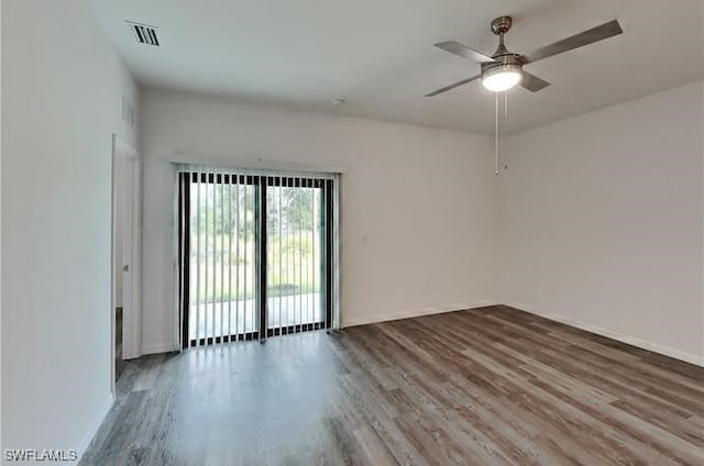 spare room featuring wood-type flooring and ceiling fan