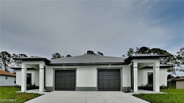 view of front of home with a garage and a front yard