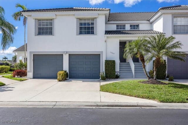1060 Partridge Cir Unit 201, Naples, FL 34104 - mediterranean / spanish-style house featuring a garage