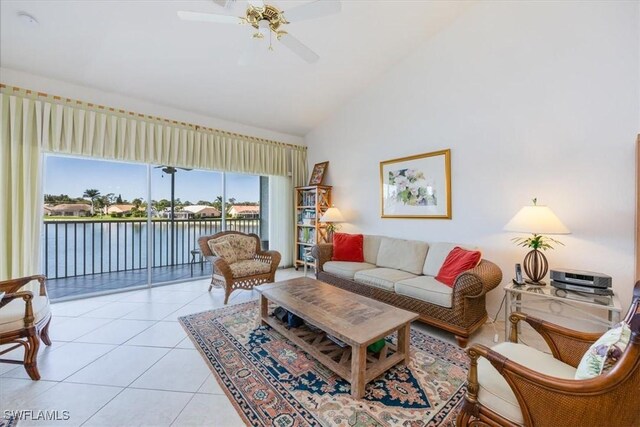 1060 Partridge Cir Unit 201, Naples, FL 34104 - living room featuring light tile patterned floors, high vaulted ceiling, ceiling fan, and a water view
