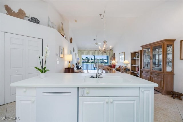 1060 Partridge Cir Unit 201, Naples, FL 34104 - kitchen featuring white cabinetry, sink, light tile patterned flooring, and an island with sink