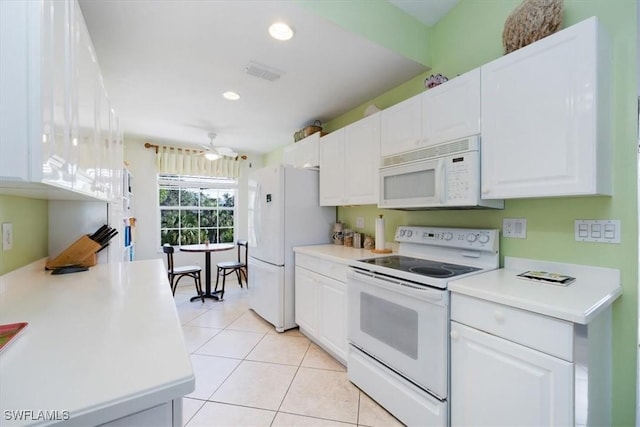 1060 Partridge Cir Unit 201, Naples, FL 34104 - kitchen with light tile patterned floors, white appliances, white cabinets, and ceiling fan