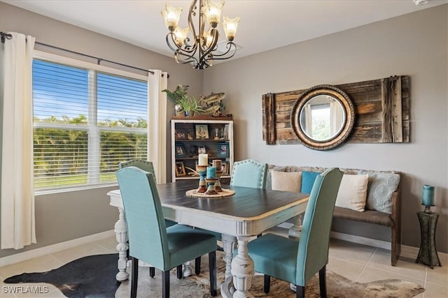 dining area with light tile patterned floors and an inviting chandelier