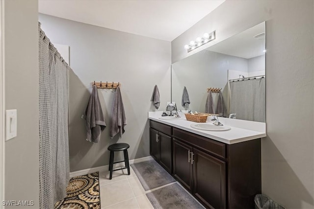 bathroom with tile patterned flooring, a shower with curtain, and vanity