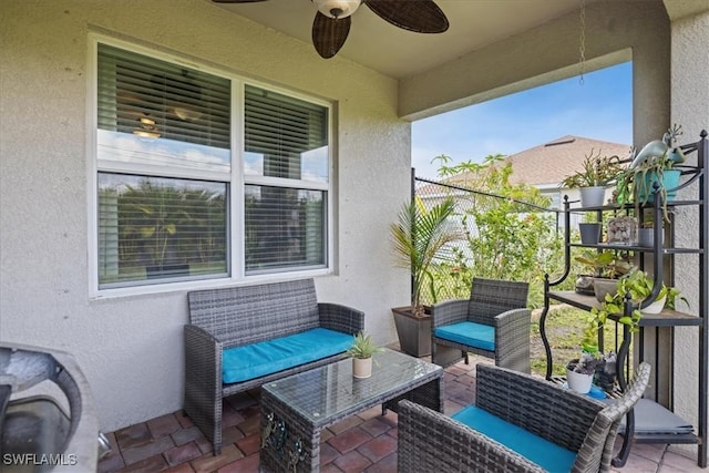 balcony with ceiling fan, a patio area, and outdoor lounge area