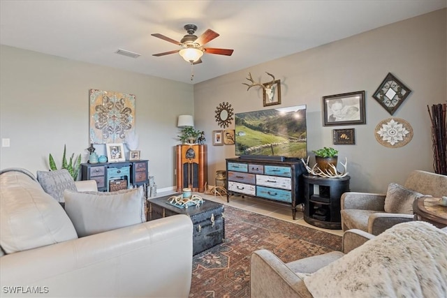 tiled living room featuring ceiling fan