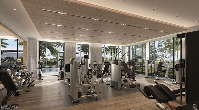 workout area with a wall of windows and wood finished floors