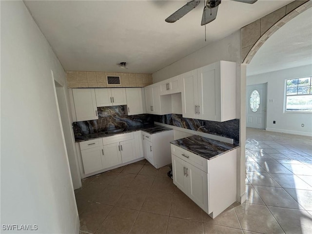 kitchen featuring light tile patterned floors, tasteful backsplash, and white cabinetry