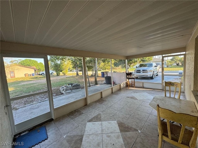 unfurnished sunroom featuring wood ceiling