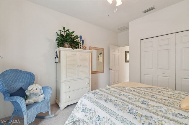 bedroom with light colored carpet and a closet