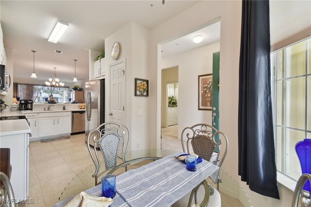 15011 Sandpiper Preserve Blvd Unit 106, Fort Myers, FL 33919 - dining area featuring light tile patterned floors and a chandelier