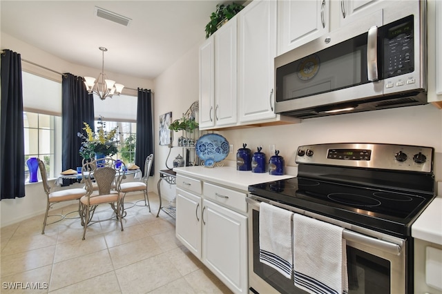15011 Sandpiper Preserve Blvd Unit 106, Fort Myers, FL 33919 - kitchen featuring stainless steel appliances, a chandelier, white cabinets, light countertops, and light tile patterned floors