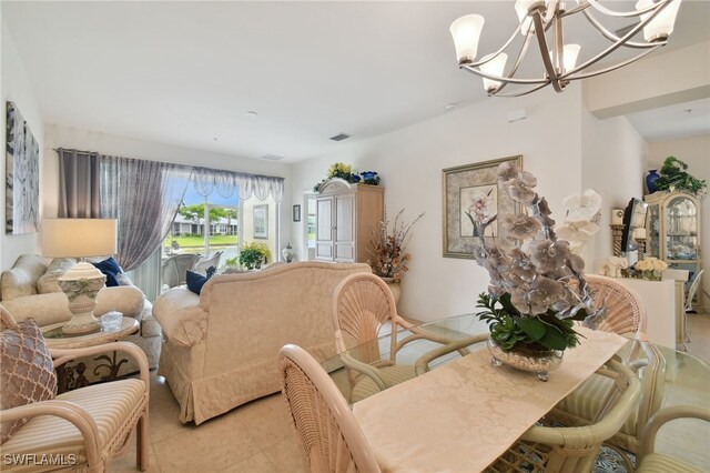 tiled living room featuring a notable chandelier