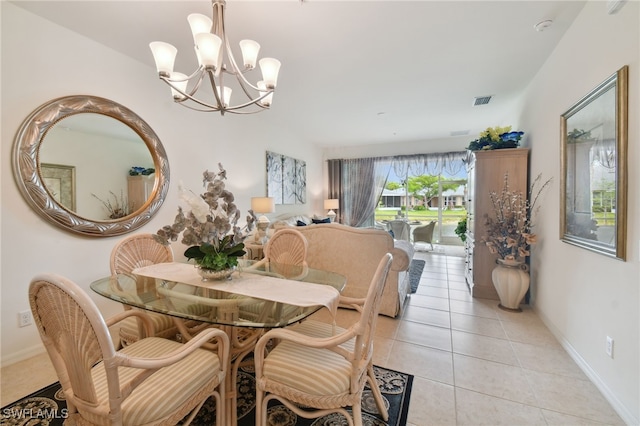 15011 Sandpiper Preserve Blvd Unit 106, Fort Myers, FL 33919 - dining space featuring light tile patterned floors, a chandelier, and baseboards