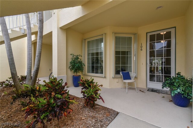 view of exterior entry featuring a patio area