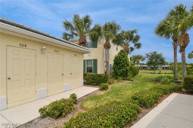 doorway to property with a yard