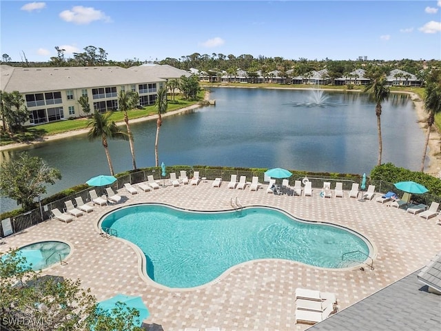 view of pool featuring a water view and a patio