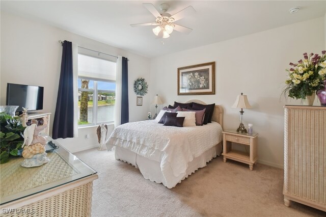 bedroom with light carpet and ceiling fan