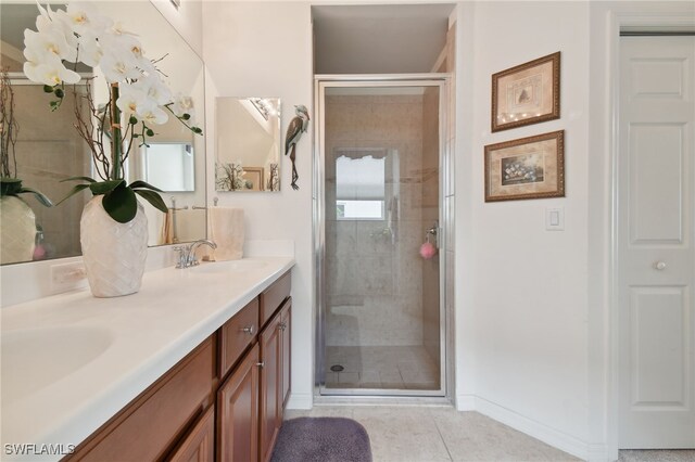 bathroom with vanity, tile patterned flooring, and a shower with shower door