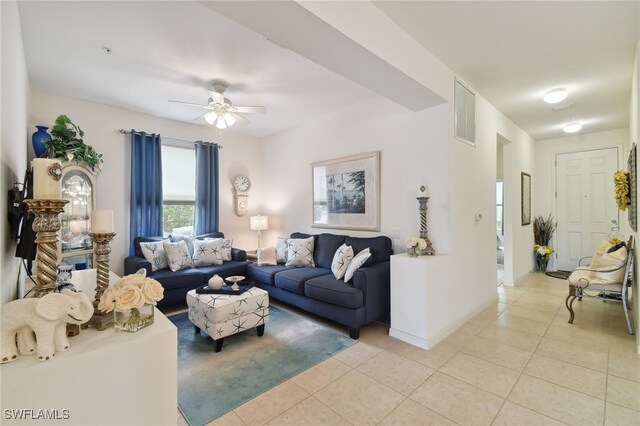 living room featuring light tile patterned floors and ceiling fan