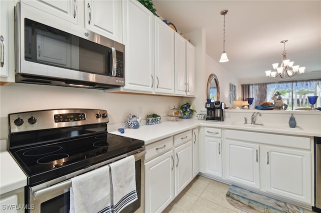 15011 Sandpiper Preserve Blvd Unit 106, Fort Myers, FL 33919 - kitchen with appliances with stainless steel finishes, a chandelier, light tile patterned floors, white cabinetry, and light countertops