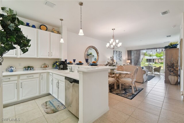 kitchen with light tile patterned floors, white cabinetry, hanging light fixtures, stainless steel dishwasher, and kitchen peninsula