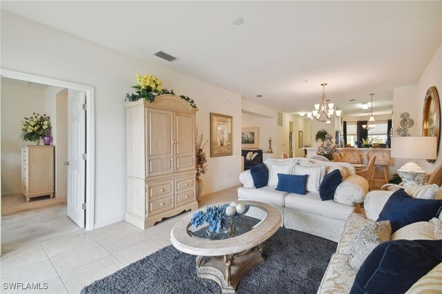 living room featuring light tile patterned floors and a chandelier