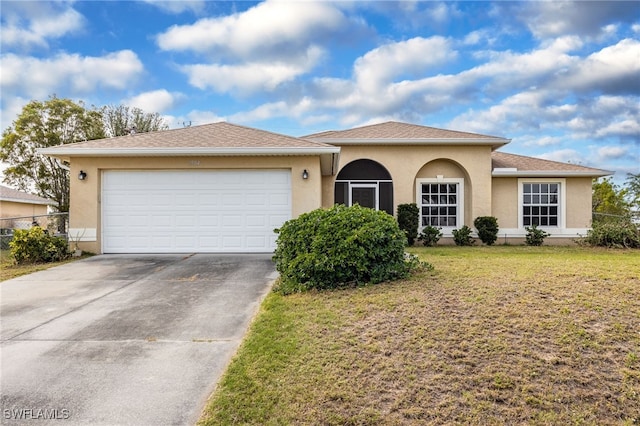 view of front of property with a garage and a front yard