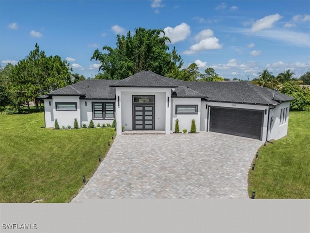 prairie-style home with a garage and a front yard