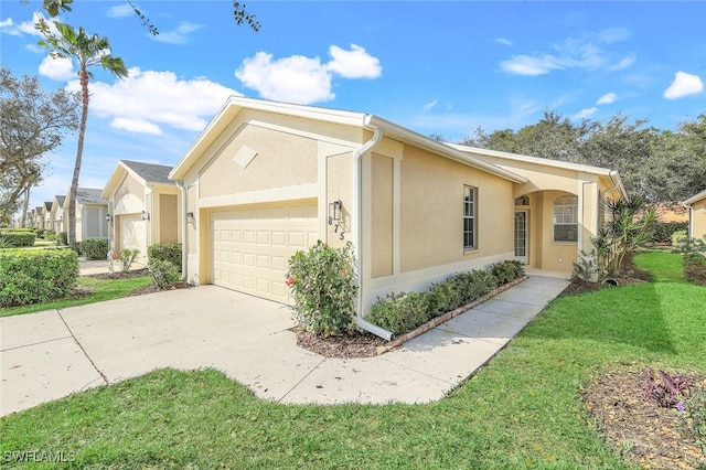 view of front of property with a garage and a front lawn